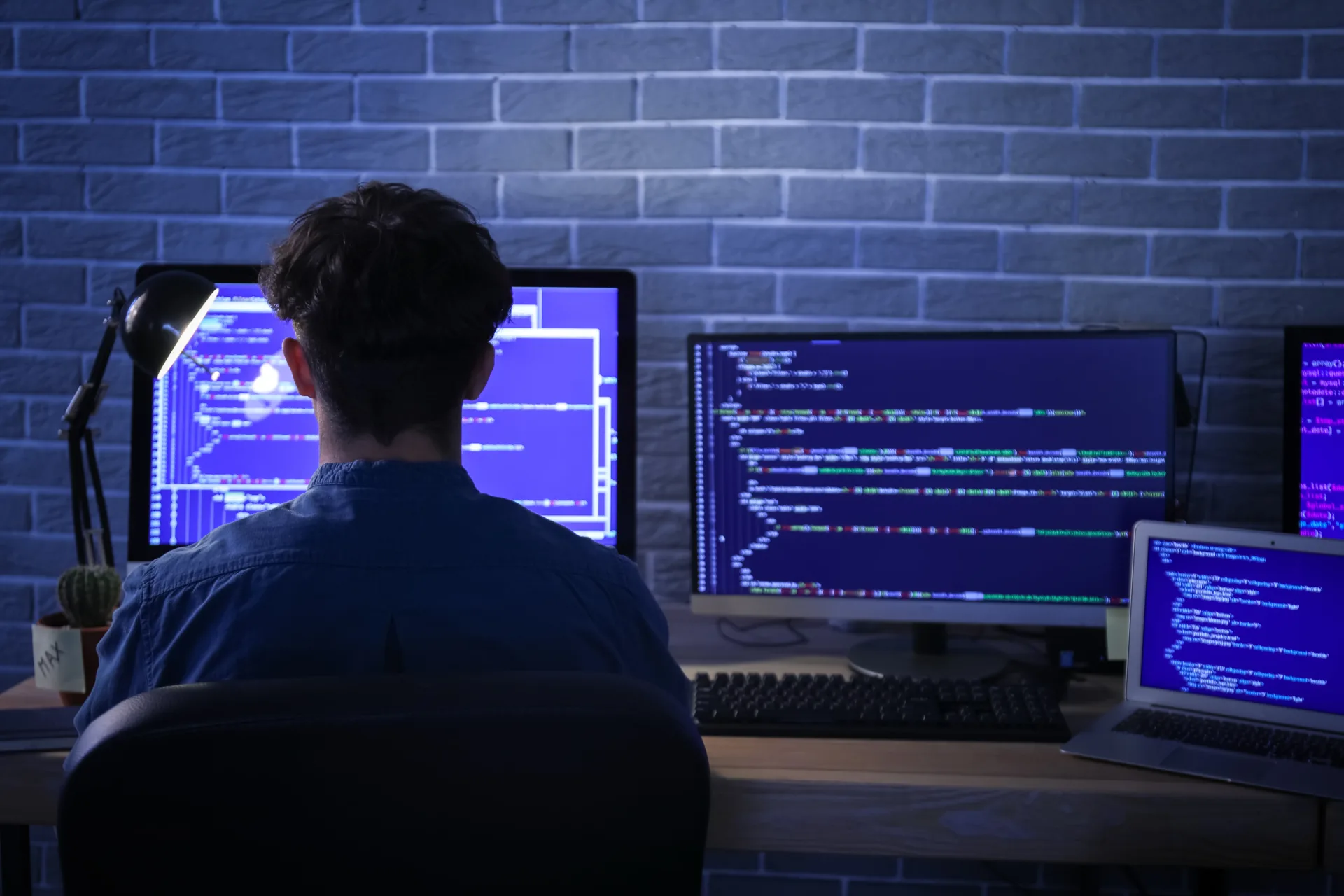 male programmer working with computer in office at night - Digital Mountain - SEO agency in Lancashire